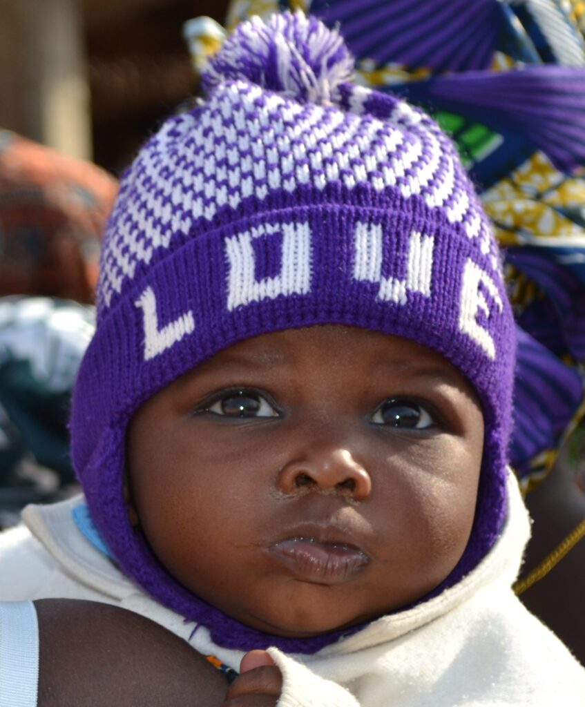 Healthy baby with knitted cap.